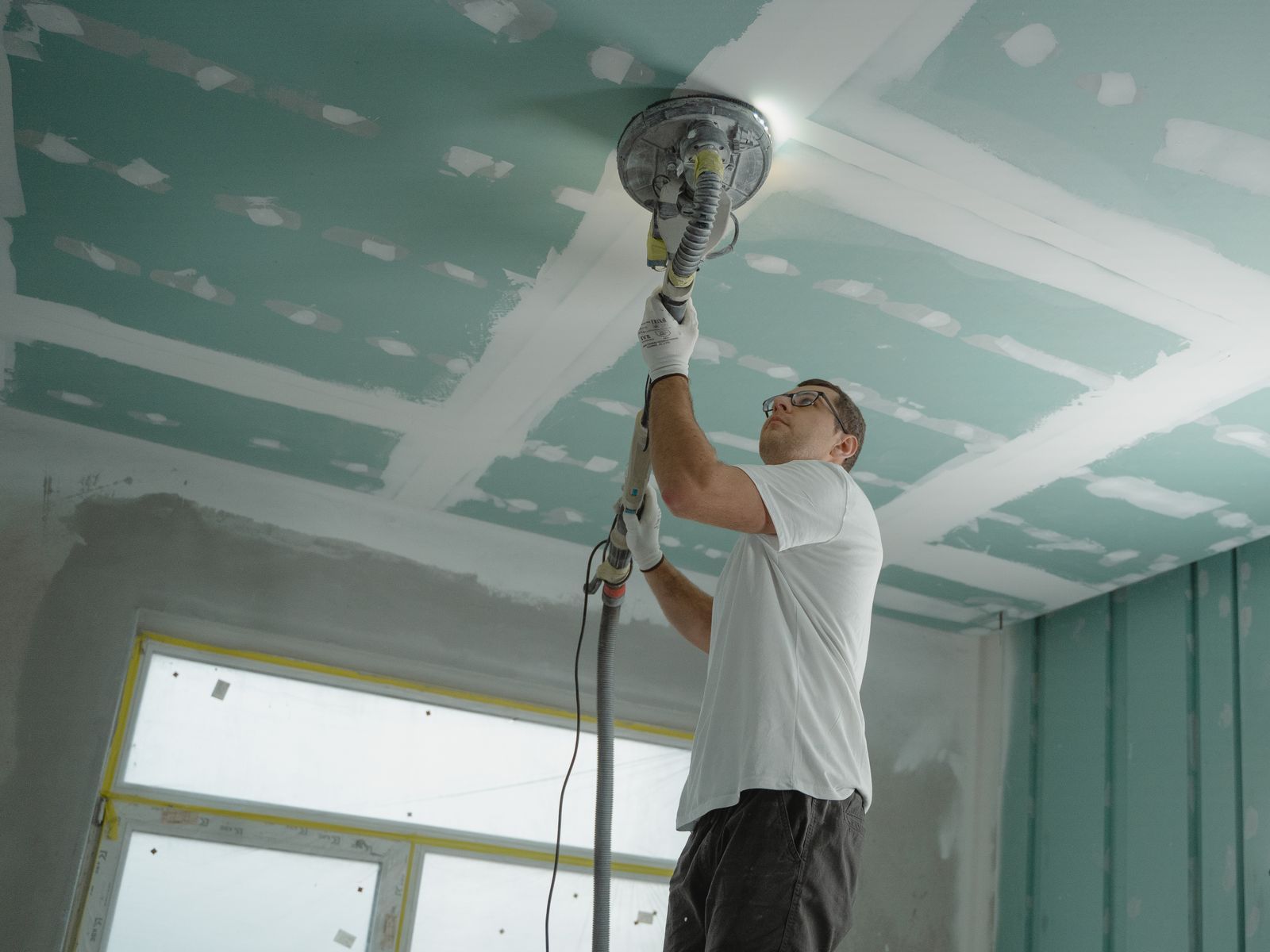 Sanding a new drywall ceiling