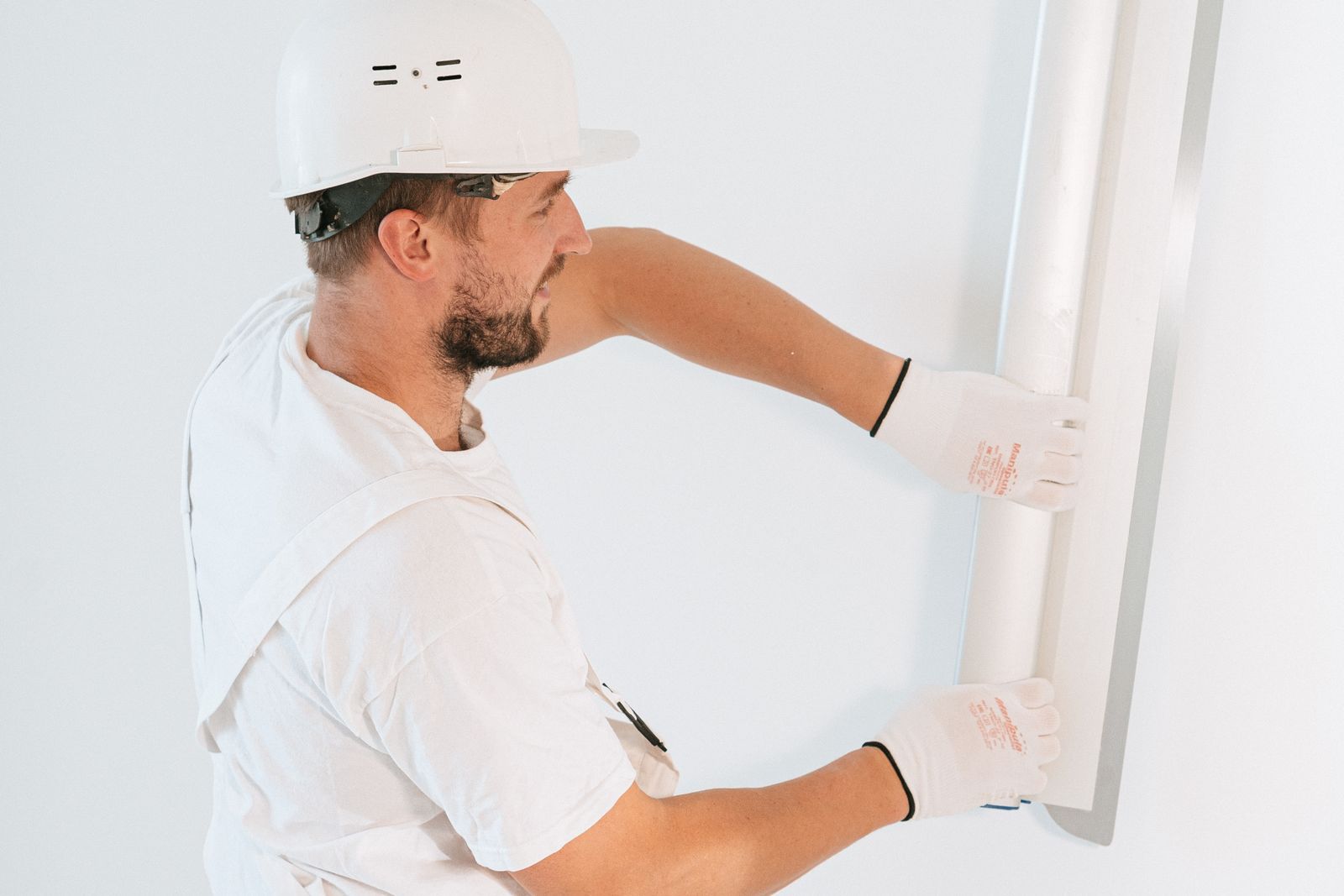 Installer hanging a drywall sheet