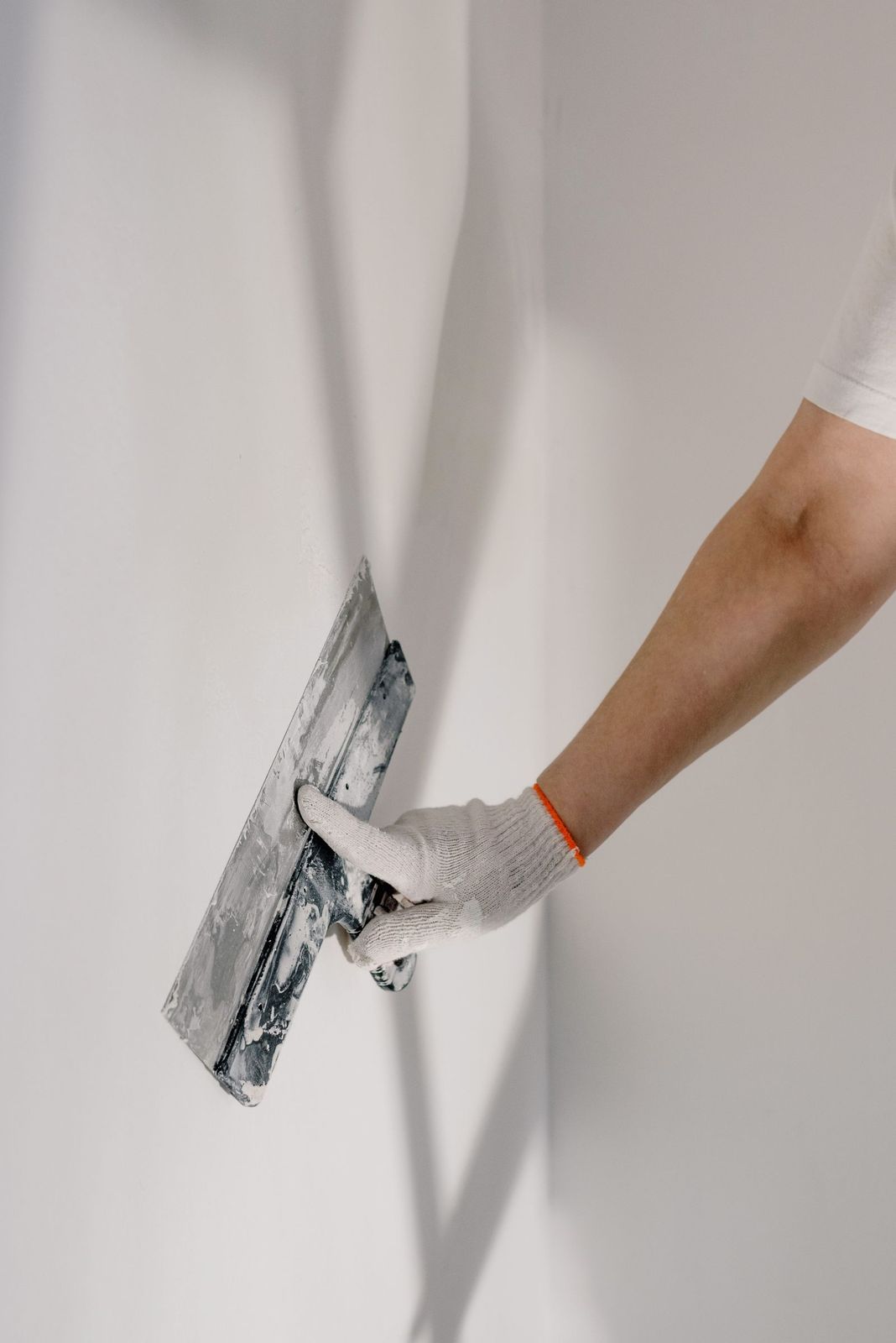 Patching a wall with a putty knife